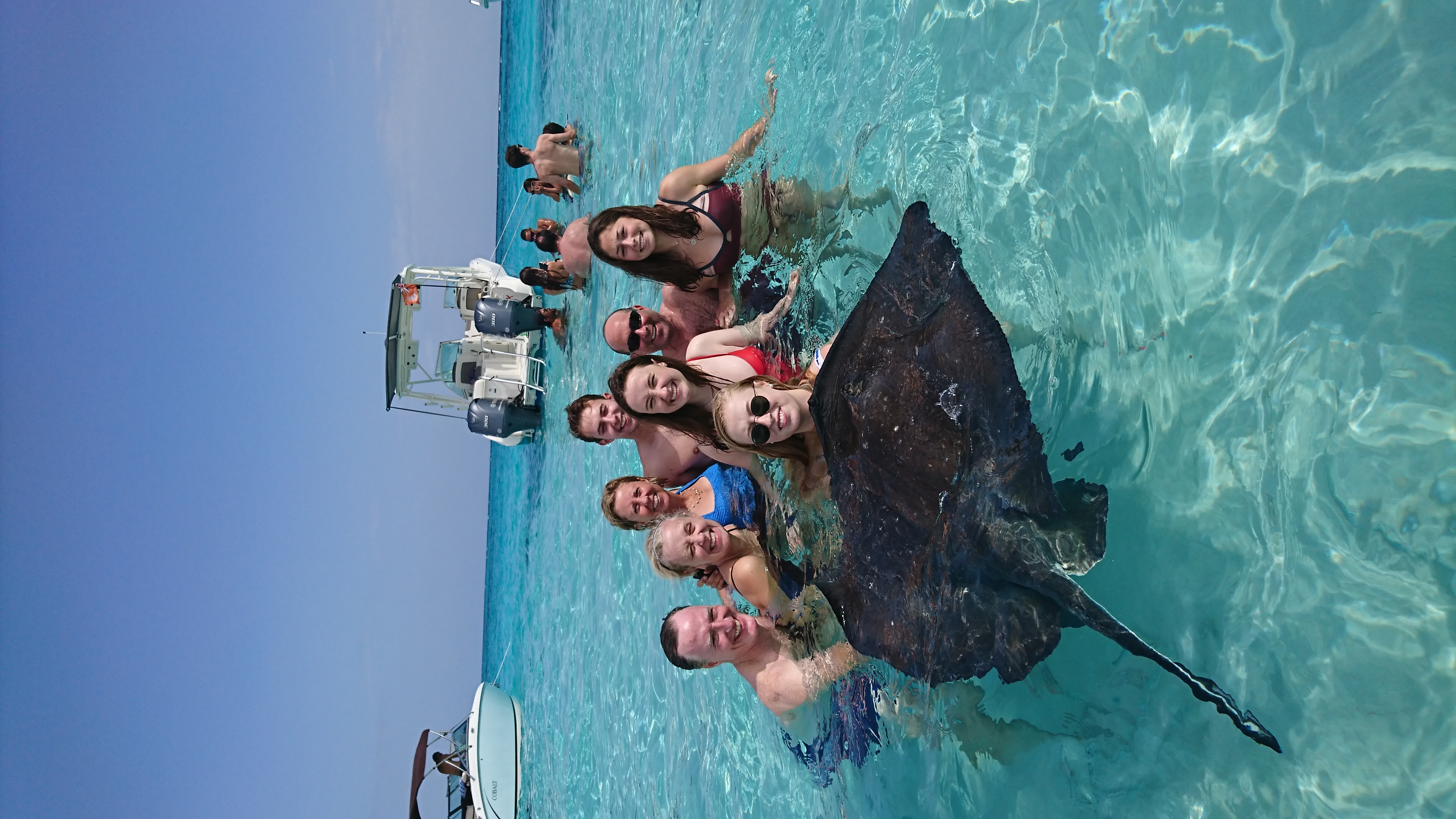 Group holding stingray at Stingray City